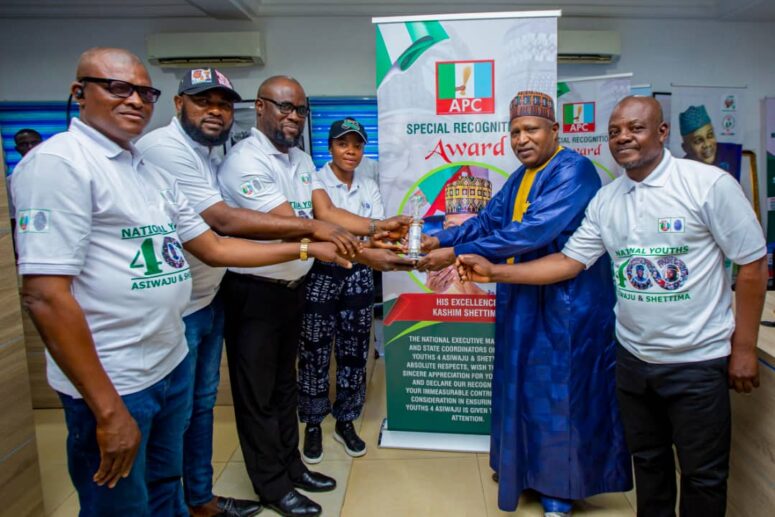 Professor Liberty , right receives the award for Shettima