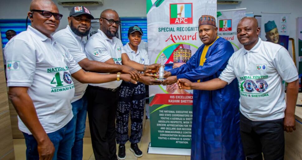 Professor Liberty , right receives the award for Shettima